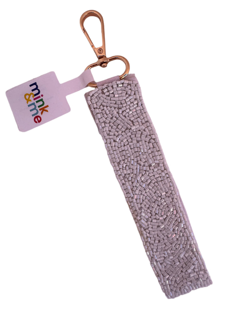Beaded keychain with a 'mink & me' tag on a light pink background