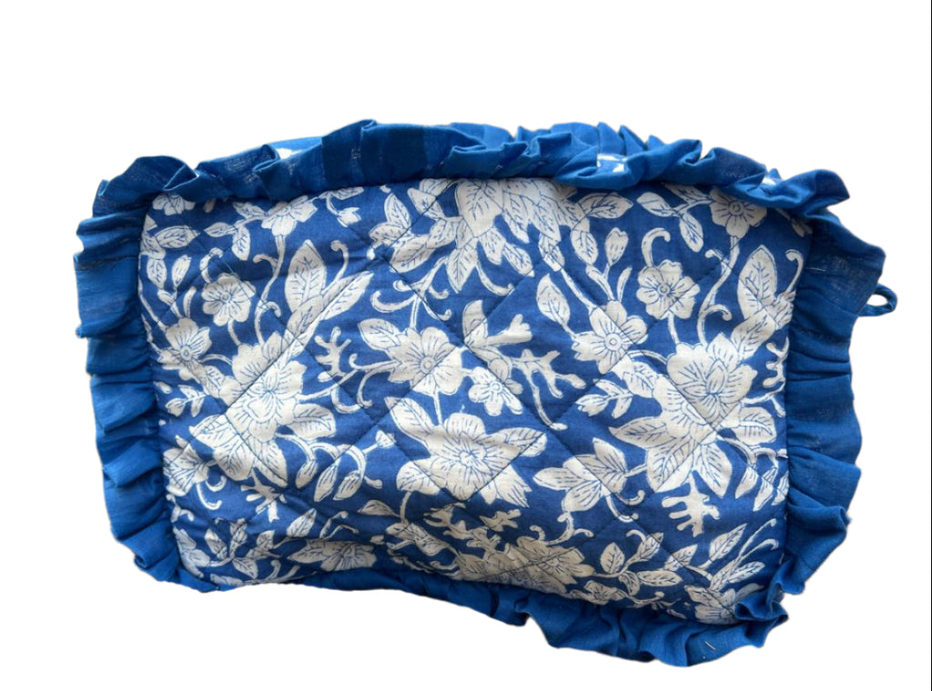 Blue floral-patterned fabric pouch on a natural background