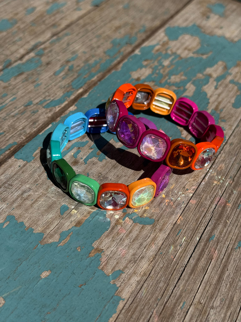 Colorful bracelet with gemstones on a wooden surface